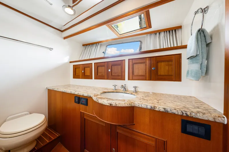 Slide: The Image of Luxurious bathroom in 2017 Marlow Explorer 49E yacht with wooden cabinets and marble countertop. - 45