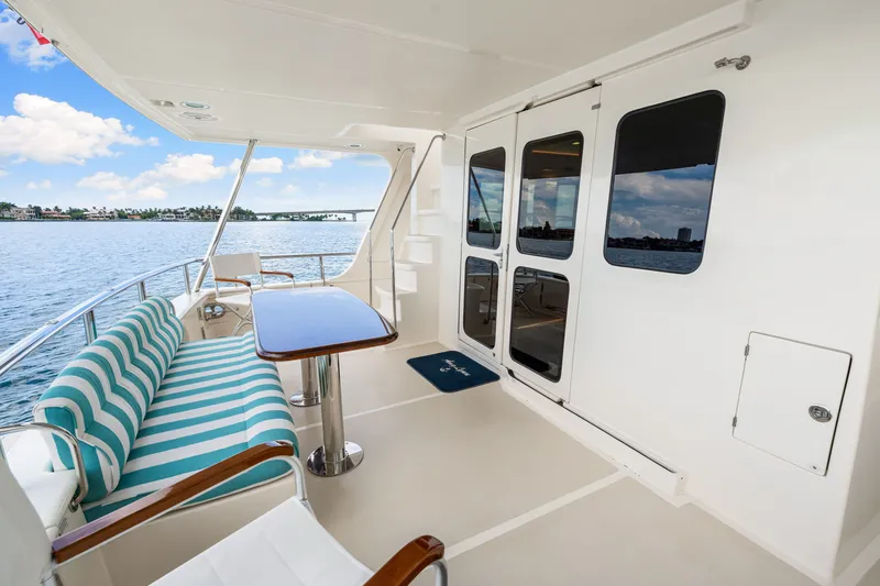 Slide: The Image of 2017 Marlow Explorer 49E yacht deck with striped seating and ocean view. - 18
