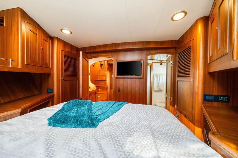 Slide: The Image of Luxurious cabin interior of 2017 Marlow Explorer 49E yacht with wood paneling and modern amenities. - 48