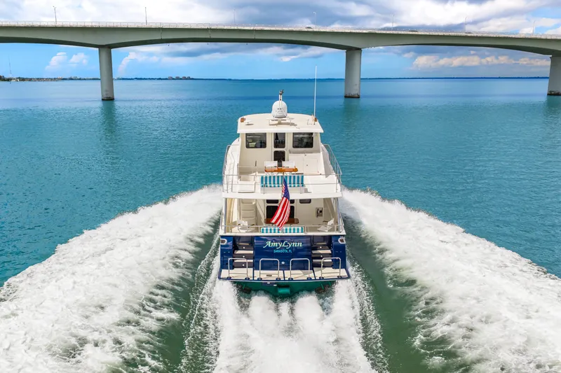 Slide: The Image of 2017 Marlow Explorer 49E yacht cruising under a bridge on a sunny day. - 5