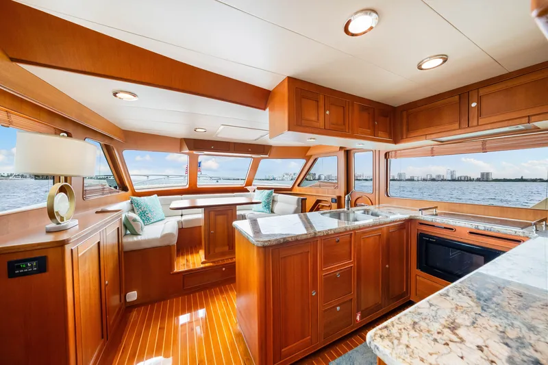 Slide: The Image of Luxurious interior of 2017 Marlow Explorer 49E yacht with wooden cabinetry and waterfront views. - 38