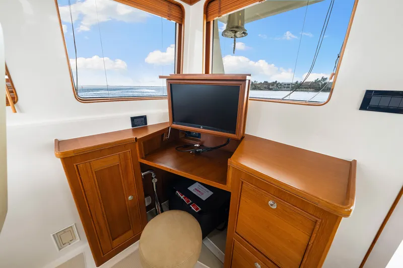 Slide: The Image of Interior of 2017 Marlow Explorer 49E yacht with wooden cabinetry and a small desk. - 33