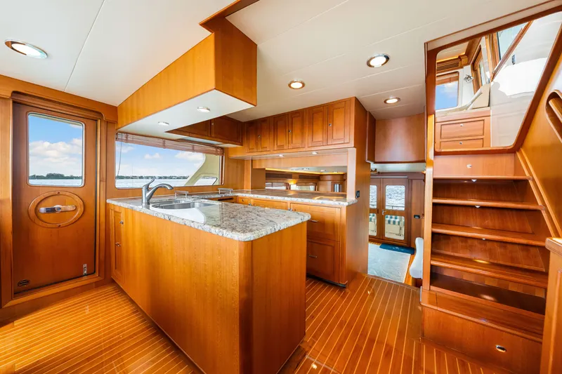 Slide: The Image of Luxurious 2017 Marlow Explorer 49E yacht interior with wooden cabinetry and granite countertops. - 39