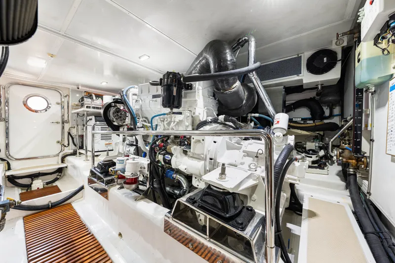 Slide: The Image of Engine room of 2017 Marlow Explorer 49E yacht, showcasing complex machinery and equipment. - 54