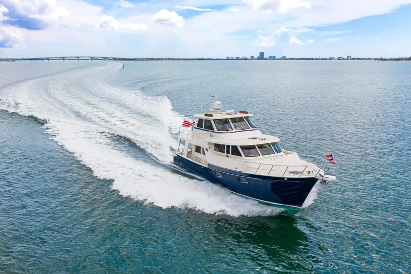 Slide: The Image of 2017 Marlow Explorer 49E yacht cruising on open water under a clear sky. - 4