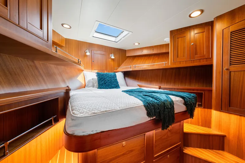 Slide: The Image of Luxurious cabin interior of 2017 Marlow Explorer 49E yacht with wood finish and skylight. - 47