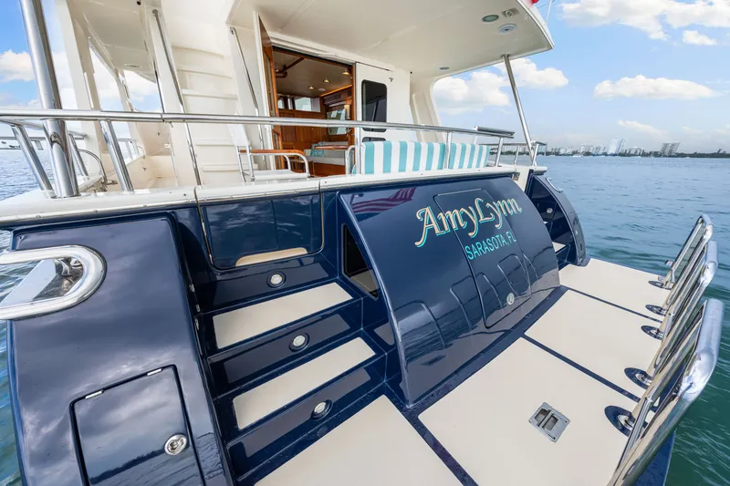 Slide: The Image of 2017 Marlow Explorer 49E yacht, rear view, docked on calm water under a clear sky. - 19