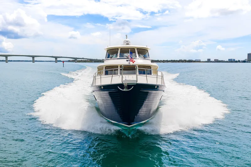 Slide: The Image of 2017 Marlow Explorer 49E yacht cruising on open water with bridge in background. - 6