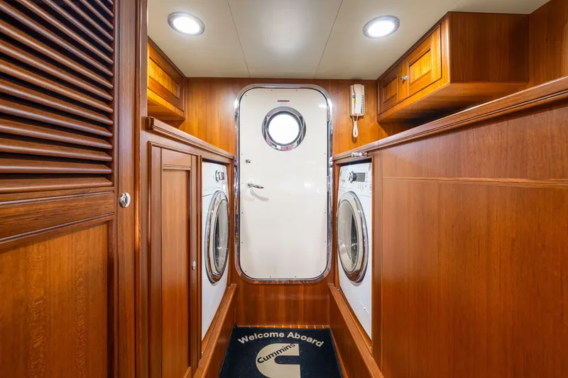 Slide: The Image of Laundry area on 2017 Marlow Explorer 49E yacht with wood paneling and appliances. - 50