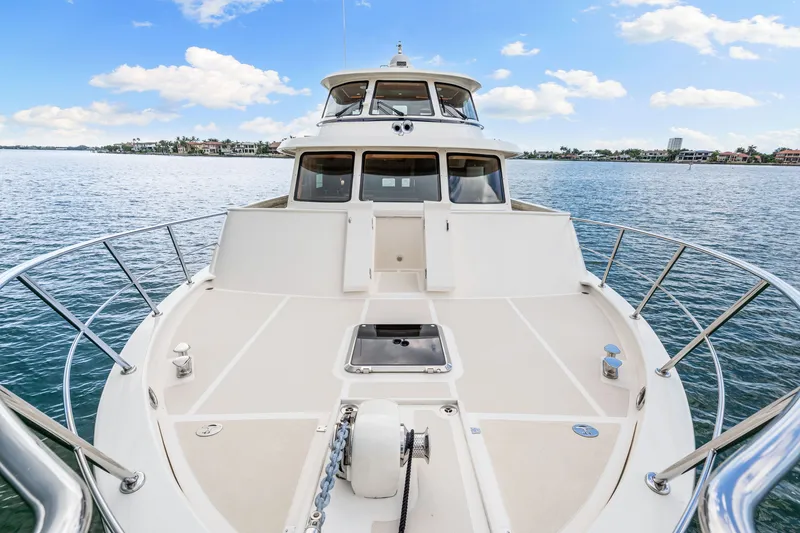 Slide: The Image of 2017 Marlow Explorer 49E yacht on calm water, showcasing spacious deck and sleek design. - 8