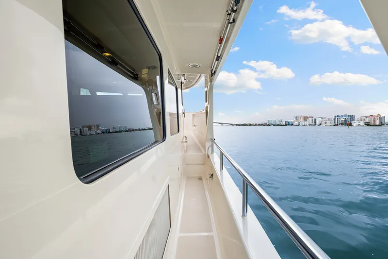 Slide: The Image of Side deck view of 2017 Marlow Explorer 49E yacht on calm waters. - 13