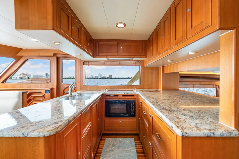 Slide: The Image of Luxurious 2017 Marlow Explorer 49E yacht kitchen with granite countertops and wooden cabinetry. - 40