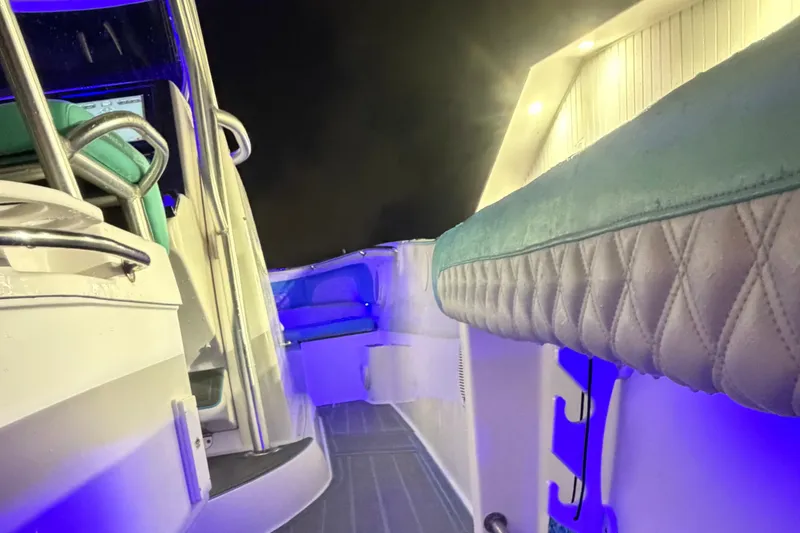 Slide: The Image of 2007 Pro-Line 29 Super Sport boat interior with blue LED lighting and cushioned seating. - 2