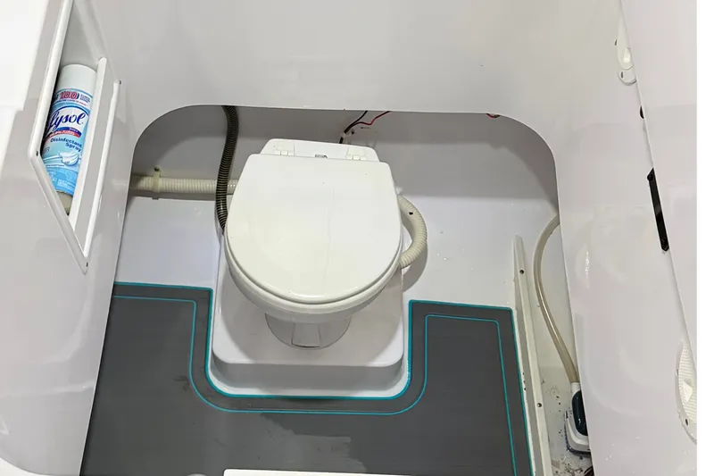 Slide: The Image of 2007 Pro-Line 29 Super Sport boat bathroom with toilet and cleaning supplies. - 4