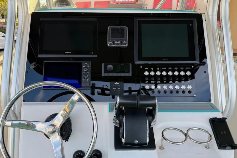 Slide: The Image of 2007 Pro-Line 29 Super Sport boat dashboard with steering wheel and electronic controls. - 5