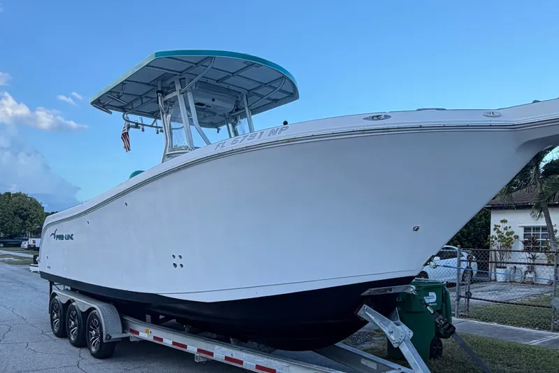 The Image of 2007 Pro-Line 29 Super Sport boat on trailer, parked on a residential street. - 0