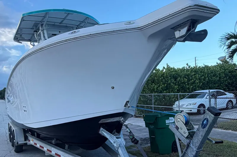 Slide: The Image of 2007 Pro-Line 29 Super Sport boat on trailer, parked outdoors. - 8