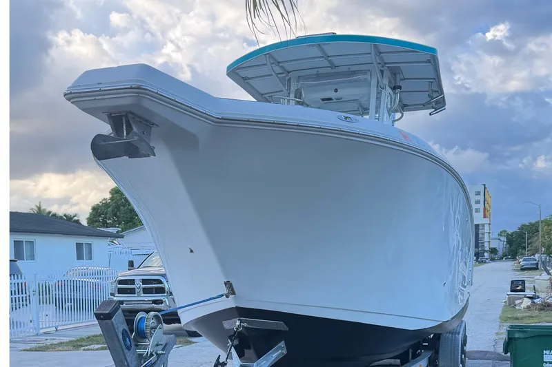 Slide: The Image of 2007 Pro-Line 29 Super Sport boat on trailer, parked in residential area. - 6