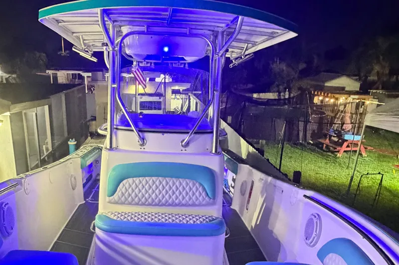 Slide: The Image of 2007 Pro-Line 29 Super Sport boat illuminated at night with blue lighting. - 1