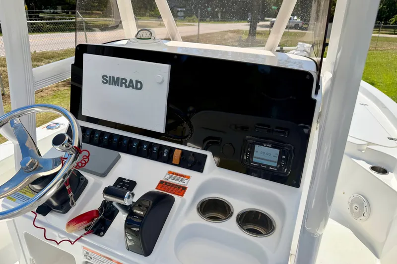 Slide: The Image of 2017 Sea Hunt BX25BR boat dashboard with Simrad display and Yamaha controls. - 10