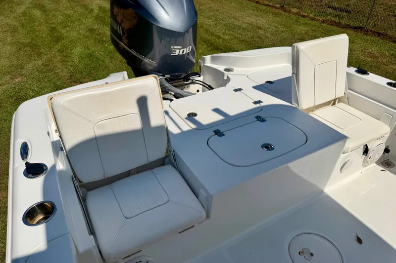 Slide: The Image of 2017 Sea Hunt BX25BR boat with Yamaha 300 engine, featuring white seating and storage compartments. - 9
