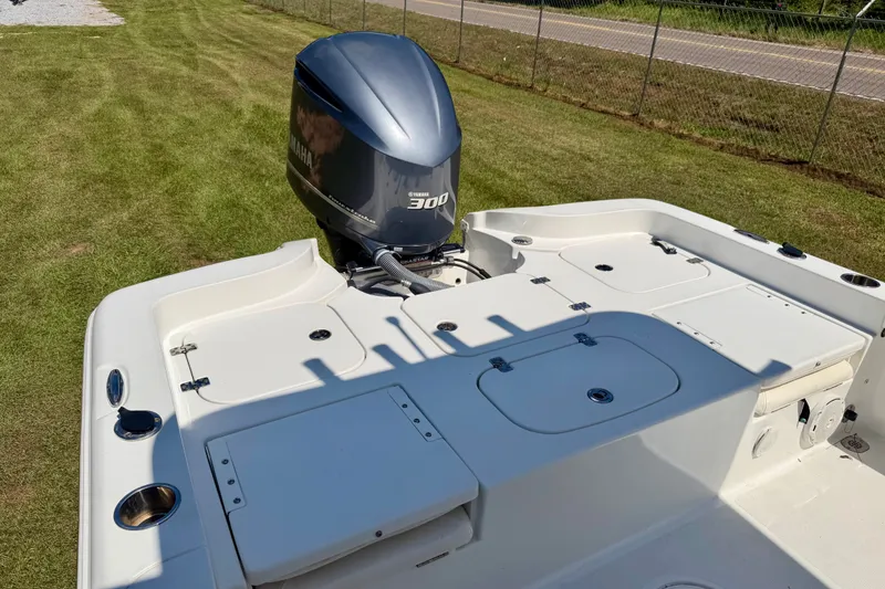 Slide: The Image of 2017 Sea Hunt BX25BR boat with Yamaha 300 engine on grassy area. - 8