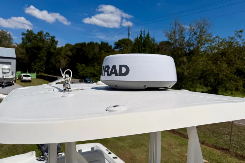 Slide: The Image of 2017 Sea Hunt BX25BR boat with radar equipment on top, clear sky background. - 6