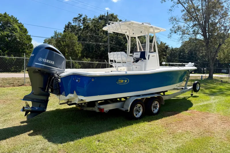 Slide: The Image of 2017 Sea Hunt BX25BR boat with Yamaha engine on trailer, parked on grass. - 3