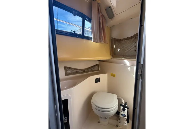 Slide: The Image of 2005 Grady White 282 Sailfish boat bathroom interior with toilet and window. - 26