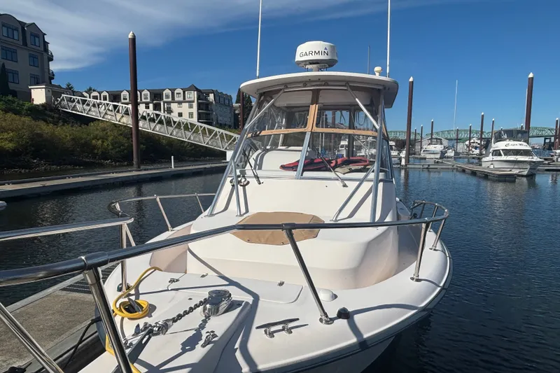Slide: The Image of 2005 Grady White 282 Sailfish boat docked at a marina with clear blue skies. - 21