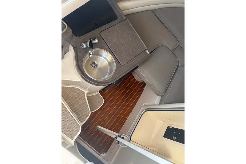 Slide: The Image of 2005 Grady White 282 Sailfish cabin interior with sink and seating area. - 25