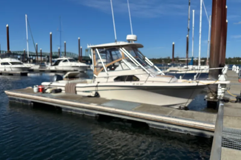 Slide: The Image of 2005 Grady White 282 Sailfish boat docked at marina under clear blue sky. - 1