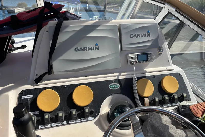 Slide: The Image of 2005 Grady White 282 Sailfish dashboard with Garmin navigation and control panel. - 8