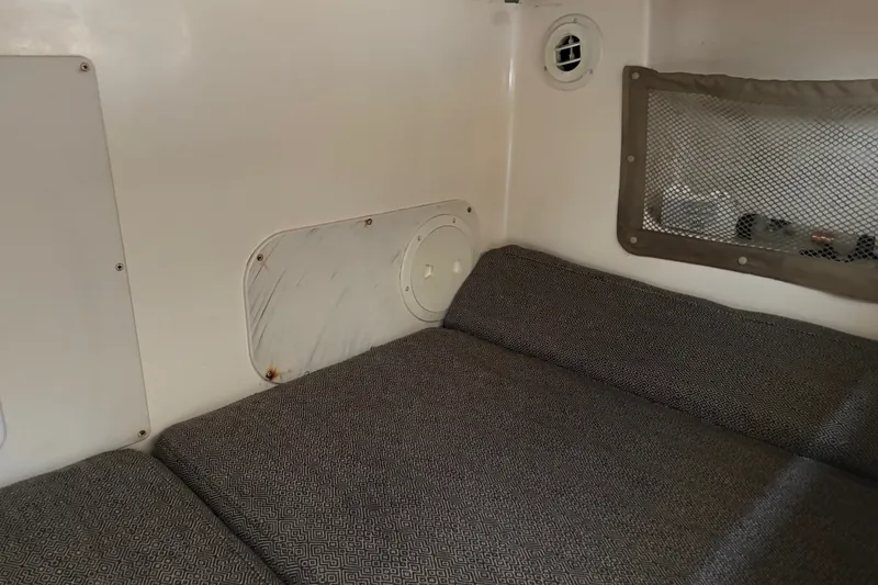 Slide: The Image of Interior cabin of 2005 Grady White 282 Sailfish boat with cushioned seating. - 14