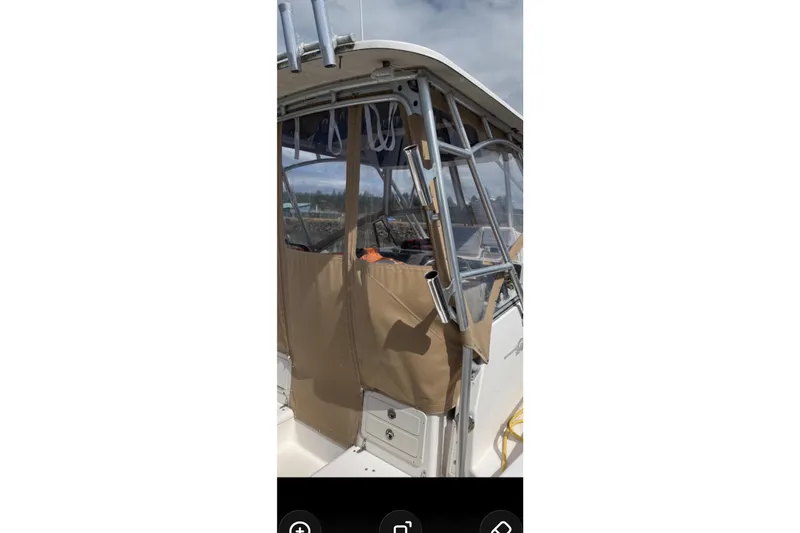 Slide: The Image of 2005 Grady White 282 Sailfish boat with tan canvas enclosure and metal framework. - 22