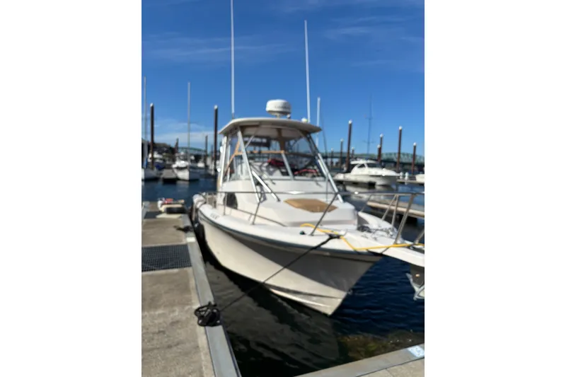 Slide: The Image of 2005 Grady White 282 Sailfish boat docked at marina under clear blue sky. - 3