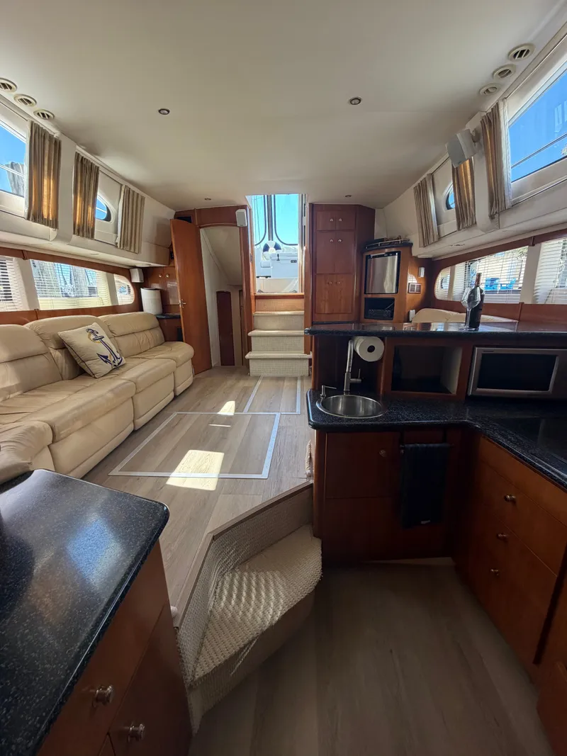 Slide: The Image of Interior of a 2000 Carver 396 Motor Yacht with elegant furnishings and ample natural light. - 37