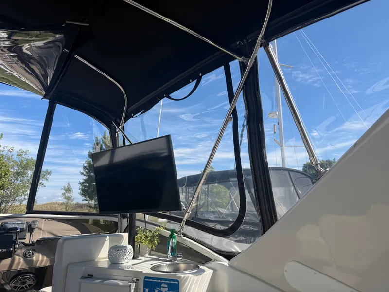 Slide: The Image of The image shows the interior of a 2000 Carver 396 Motor Yacht with a TV and small sink. - 21