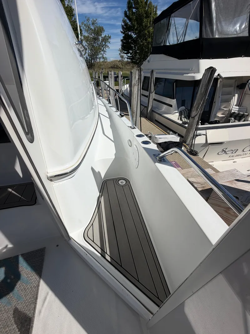 Slide: The Image of A 2000 Carver 396 Motor Yacht docked. Visible is a narrow walkway. - 32
