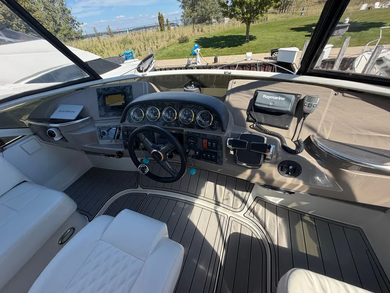 Slide: The Image of The cockpit of a 2000 Carver 396 Motor Yacht with modern navigation equipment and white seating. - 15