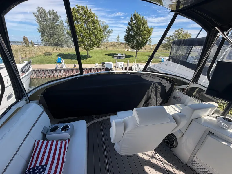 Slide: The Image of The image shows the cockpit of a 2000 Carver 396 Motor Yacht with white seating and a table. - 18