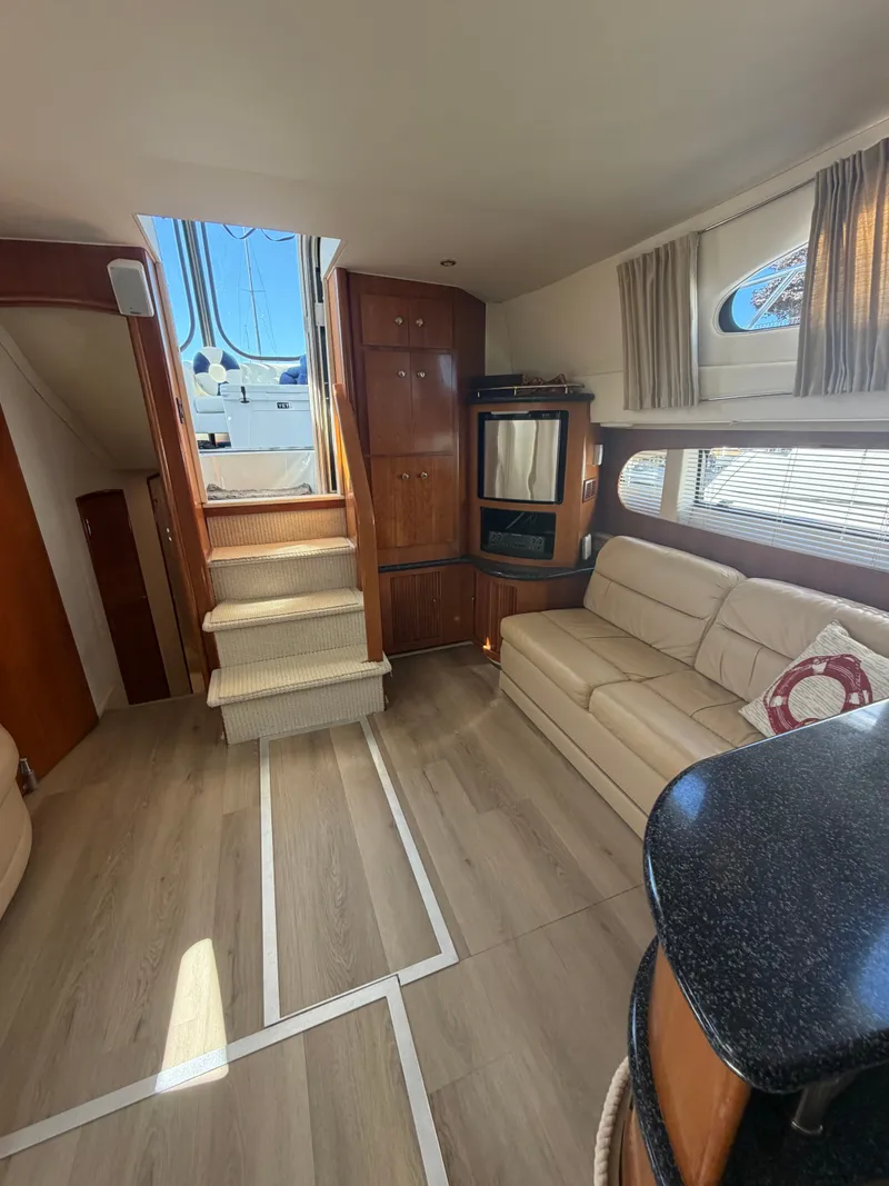 Slide: The Image of Interior of a 2000 Carver 396 Motor Yacht with sofa, stairs, and windows. - 39