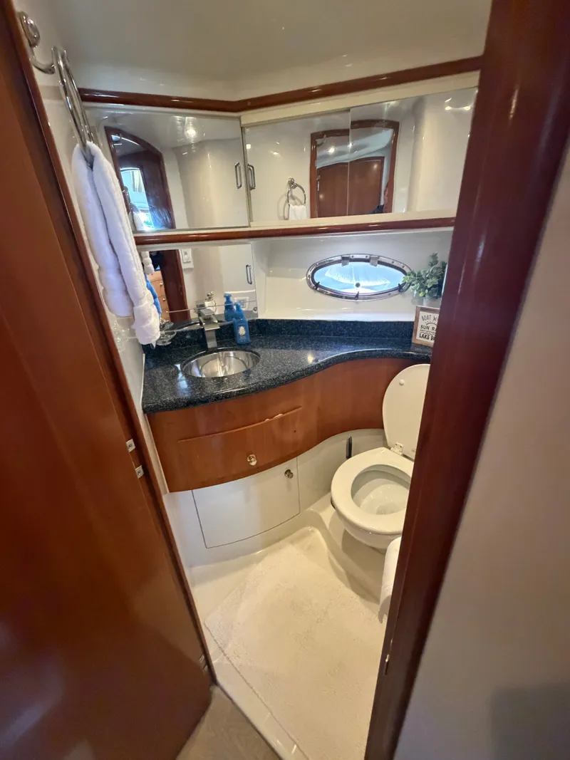Slide: The Image of The image shows a yacht bathroom with a sink, toilet, and mirror. - 48