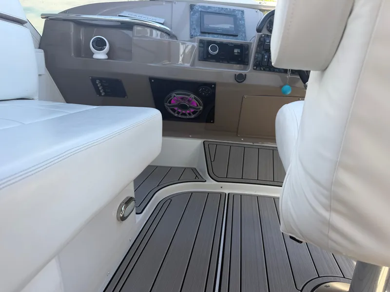 Slide: The Image of The image shows the cockpit of a 2000 Carver 396 Motor Yacht with white leather seating and modern instruments. - 31