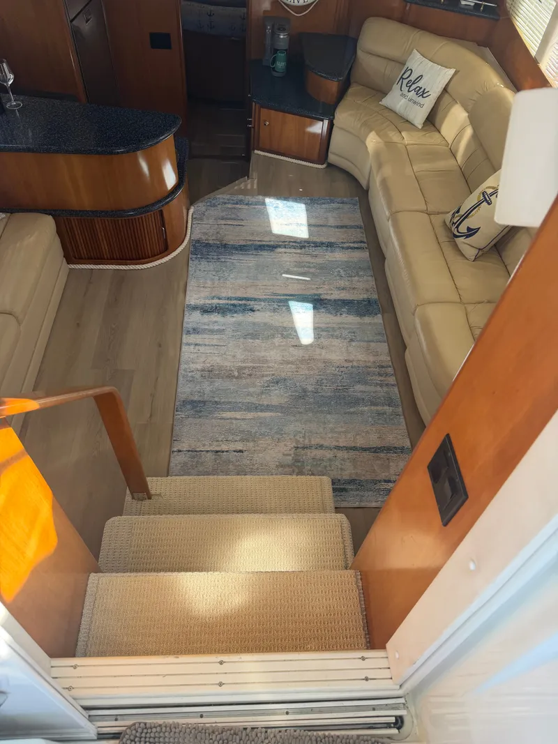 Slide: The Image of Interior of a 2000 Carver 396 Motor Yacht with beige sofa and rug. - 35