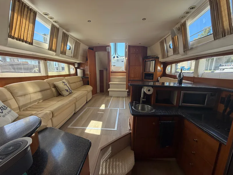 Slide: The Image of Interior of the 2000 Carver 396 Motor Yacht with elegant furnishings and large windows. - 41