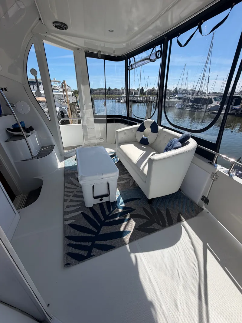 Slide: The Image of The 2000 Carver 396 Motor Yacht features a sleek interior with a sofa and marina view. - 16