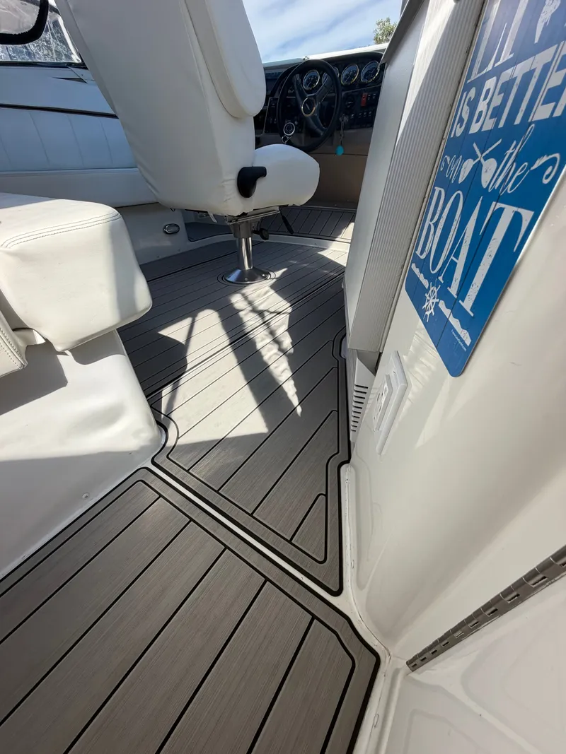 Slide: The Image of The image shows the cockpit of a 2000 Carver 396 Motor Yacht with sleek wooden flooring. - 27