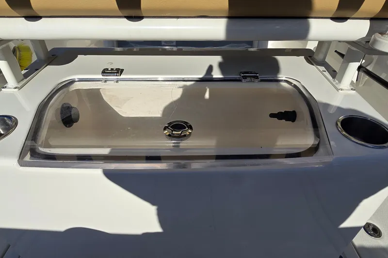 Slide: The Image of 2023 Bayliner Trophy T24CC boat livewell with transparent lid and cup holder. - 13