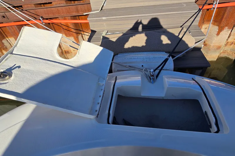 Slide: The Image of Open storage compartment on 2023 Bayliner Trophy T24CC boat docked at marina. - 24